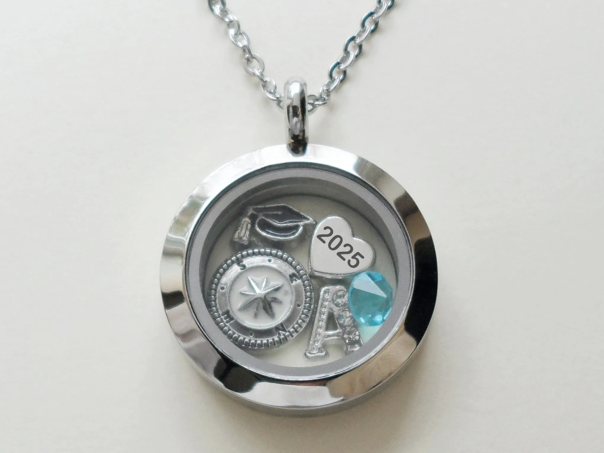 Class of 2025 Graduate Locket Necklace with Graduate Cap, 2025 Heart Charm, and Custom Letter & Birthstone - by Jewelry Everyday (Plain Edge Silver Locket)