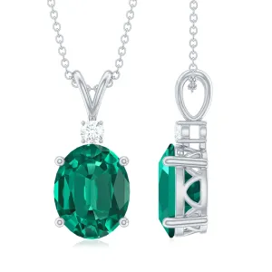 Oval Created Emerald and Moissanite Solitaire Pendant